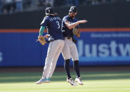 Seattle Mariners' J.P. Crawford (3) and Jesse Winker celebrate after defeating the New York Mets in a baseball game Sunday, May 15, 2022, in New York. (AP Photo/Noah K. Murray)