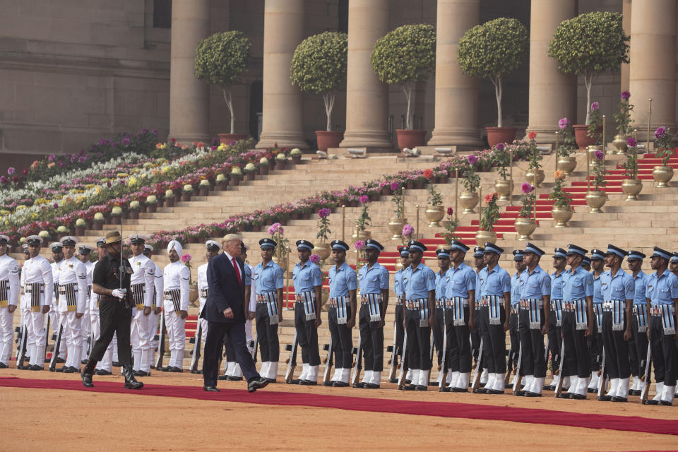 U.S. President Donald Trump reviews a guard of honor during a ceremonial reception at Rashtrapati Bhavan, the Indian Presidential Palace, in New Delhi, India, Tuesday, Feb. 25, 2020. (AP Photo/Alex Brandon)