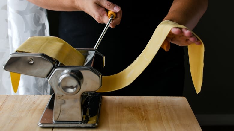person using pasta machine