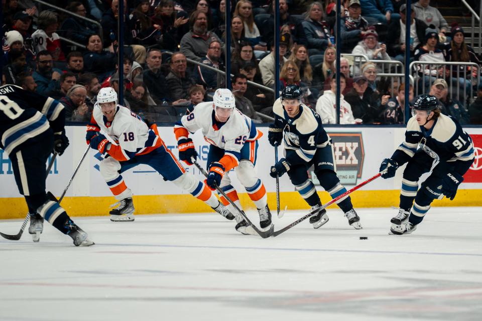 Oct 28, 2023; Columbus, Ohio, United States;
Columbus Blue Jackets center Cole Sillinger (4) and Kent Johnson (91) race against New York Islanders left wing Pierre Engvall (18) and Brock Nelson (29) for the puck during the second period of their game on Saturday, Oct. 28, 2023 at Nationwide Arena.