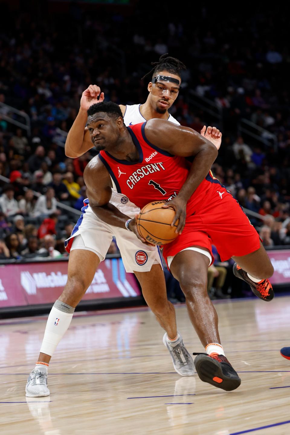 New Orleans Pelicans forward Zion Williamson dribbles against Detroit Pistons forward Tosan Evbuomwan in the first half at Little Caesars Arena, March 24, 2024.