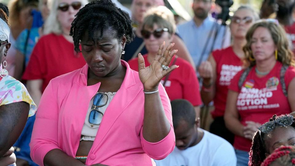 PHOTO: A woman attending a vigil for the victims of Saturday's mass shooting bows her head in prayer, Aug. 27, 2023, in Jacksonville, Fla. (John Raoux/AP)