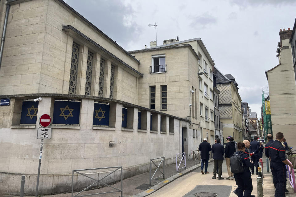 Firemen stand in front the synagogue in Rouen after a man armed with a knife and a metal bar is suspected of having set fire, Friday, May 17, 2024. French police have shot and killed a man armed with a knife and a metal bar who is suspected of having set fire to a synagogue in the Normandy city of Rouen. French police said officers were alerted early Friday morning that smoke was rising from the synagogue and came face to face with the man when they got there. (AP Photo/Jeffrey Schaeffer)