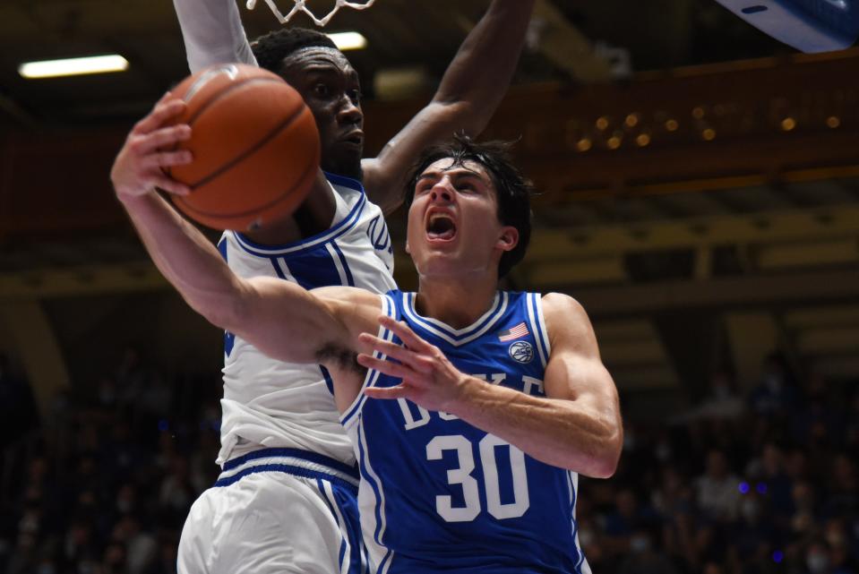 Oct 15, 2021; Durham, NC, USA;  Duke Blue Devils guard Michael Savarino (30) lays the ball up as center Mark Williams(15) defends during Duke Countdown to Craziness at Cameron Indoor Stadium. Mandatory Credit: Rob Kinnan-USA TODAY Sports