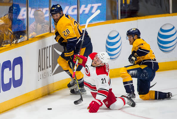 NASHVILLE, TN - OCTOBER 8: James Wisniewski #21 of the Carolina Hurricanes hits the ice as Paul Gaustad #28 and Viktor Arvidsson #38 of the Nashville Predators go after the puck during a NHL game at Bridgestone Arena on October 8, 2015 in Nashville, Tennessee. (Photo by Ronald C. Modra/NHL/Getty Images)