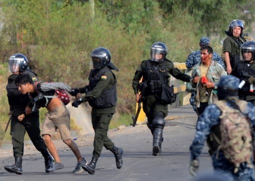 Bolivian riot police arrest Morales supporters during a protest against the interim government in Sacaba, Chapare province