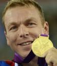 Great Britain's Chris Hoy celebrates with his gold medal on the podium during the victory ceremony for the Men's team sprint as part of the track cycling event of London 2012 Olympic games, in London