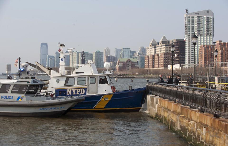 Police investigate after divers found the bodies of two people in the Hudson River near Sinatra Park, Sunday, April 13, 2014 in Hoboken, N.J. Police have not identified the victims. (AP Photo/Joe Epstein)