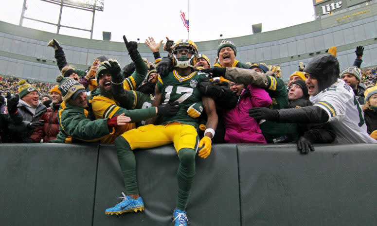 Davante Adams celebrating a touchdown with Green Bay Packers fans.