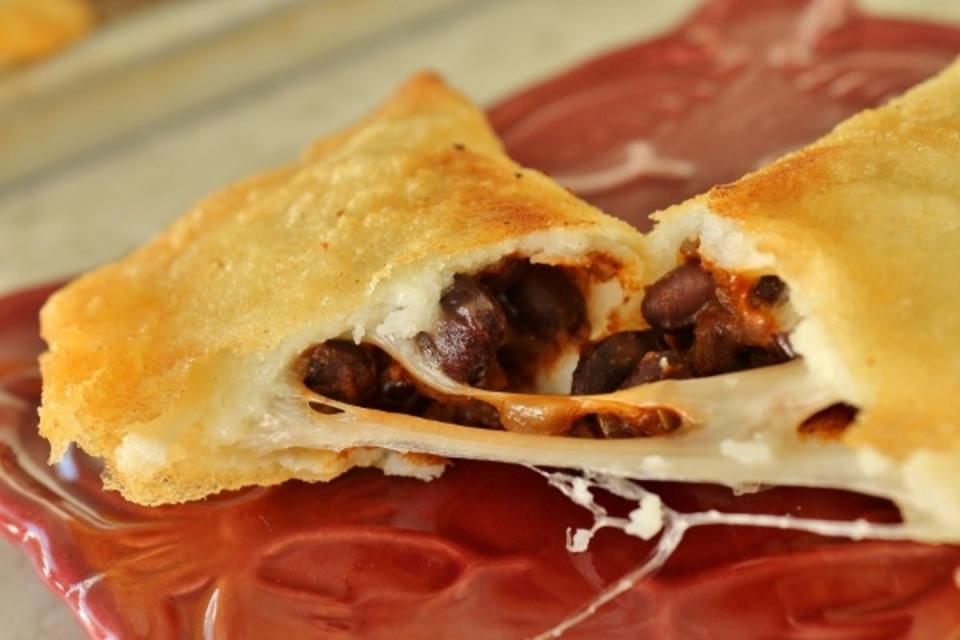 <p>Mission Food Adventure</p><p> Domino Empanadas hail from Venezuela and feature a black and white filling reminiscent of domino tiles.</p><p><strong>Get the recipe: </strong><a href="https://mission-food.com/venezuelan-black-bean-and-cheese-domino/" rel="nofollow noopener" target="_blank" data-ylk="slk:Venezuelan Black Bean and Cheese Domino Empanadas;elm:context_link;itc:0;sec:content-canvas" class="link ">Venezuelan Black Bean and Cheese Domino Empanadas</a></p>