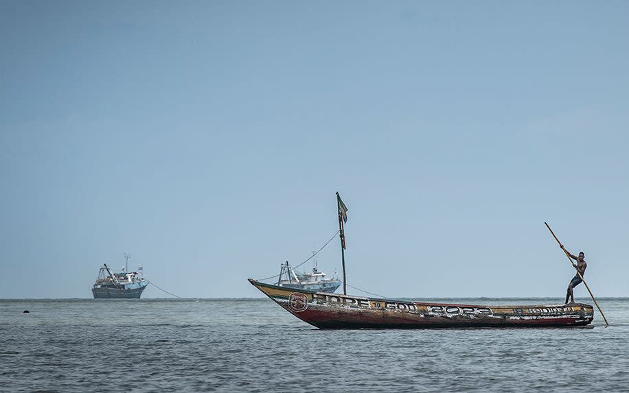 Fishermen in their boats with Chinese trawlers in the distance - Simon Townsley/The Telegraph