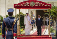 In this photo made available by Qatar News Agency, QNA, Qatari Emir Tamim bin Hamad Al Thani, and Egyptian President Abdel-Fattah el-Sissi, review an honor guard at the presidential palace in Cairo, Egypt, Saturday, June 25, 2022. Qatar's emir arrived in Cairo to hold talks with Egypt's president in his first visit since the two countries agreed to reset relations after more than seven years of diplomatic animosity. (QNA via AP)