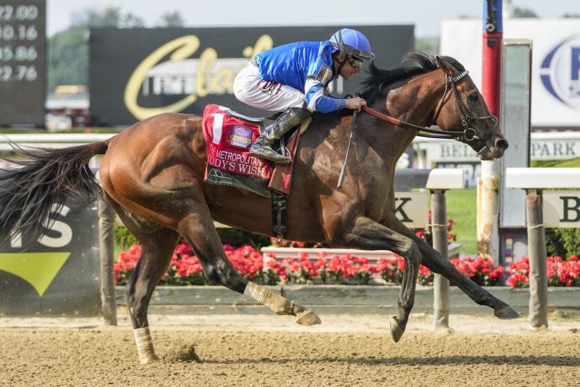 Cody's Wish, with jockey Junior Alvarado, crosses the finish line to win The Hill N' Dale Metropolitan.