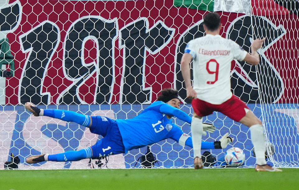 Guillermo Ochoa saves Robert Lewandowski's penalty kick in the second half.