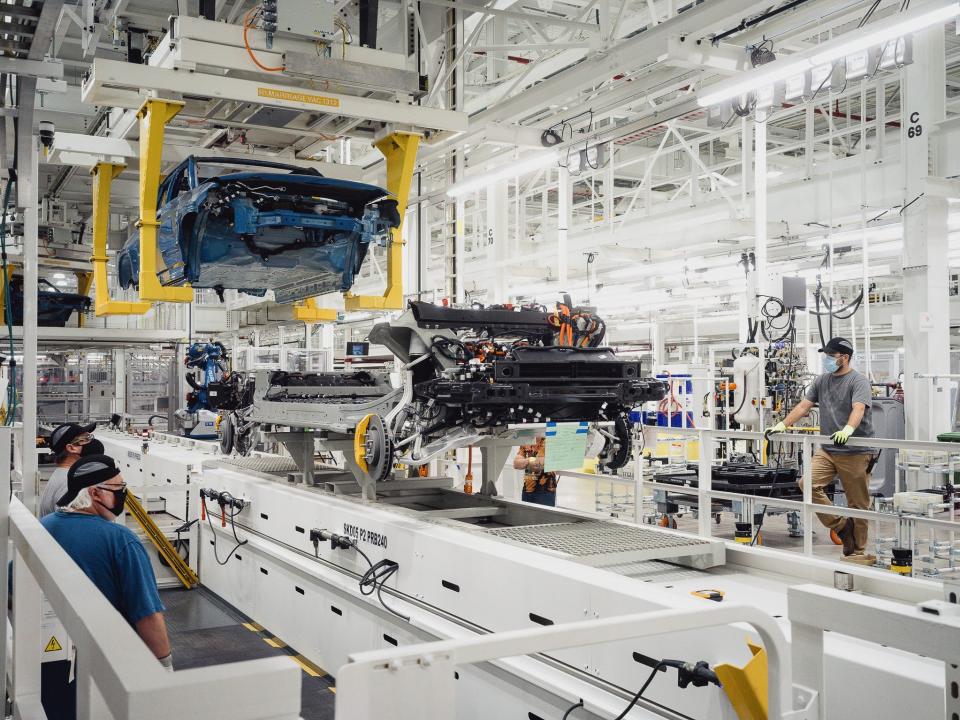 Two vehicles being assembled at Rivian's manufacturing plant in Normal, Illinois