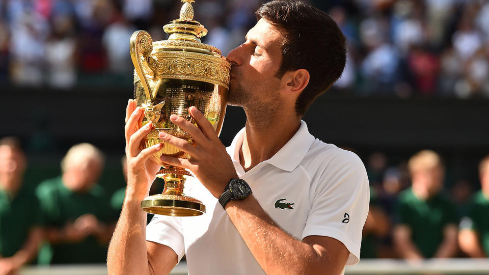 Serbia’s Novak Djokovic kisses the winners trophy after beating South Africa’s Kevin Anderson 6-2, 6-2, 7-6 in their men’s singles final match on the thirteenth day of the 2018 Wimbledon Championships at The All England Lawn Tennis Club in Wimbledon, southwest London, on July 15, 2018. (Photo by Glyn KIRK / AFP) / RESTRICTED TO EDITORIAL USE (Photo credit should read GLYN KIRK/AFP/Getty Images)