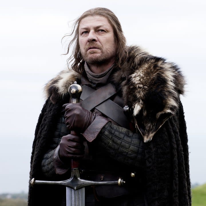 Sean Bean holds a giant sword