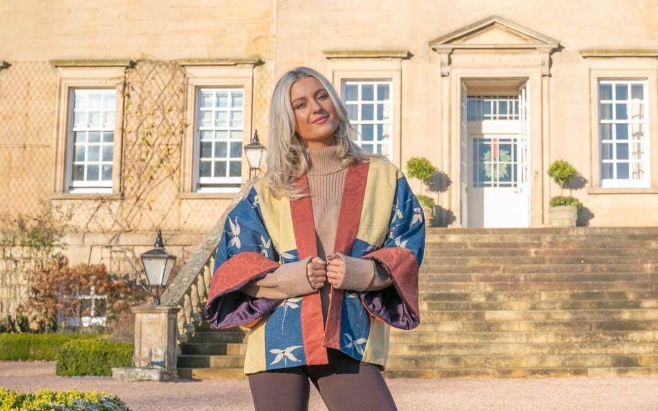 A model wears a bold denim blue and yellow damask short kimono made from material that used to adorn rooms at Buckingham Palace and Windsor Castle