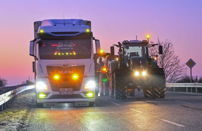 Farmers block the entrance to the A12 highway towards Berlin with their tractors as part of a statewide protest. Patrick Pleul/dpa