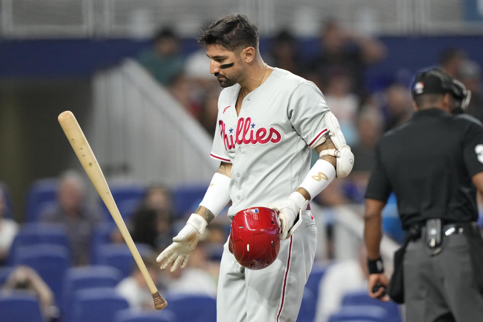 Philadelphia Phillies' Nick Castellanos tosses his bat after he struck out swinging during the fourth inning of a baseball game against the Miami Marlins, Sunday, July 9, 2023, in Miami. (AP Photo/Lynne Sladky)