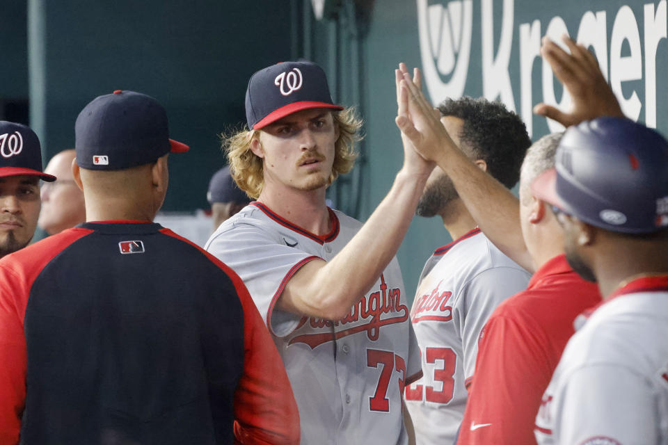 Washington Nationals starting pitcher Jackson Tetreault (72) is congratulated in the dugout after being pulled during the seventh inning of a baseball game against the Texas Rangers, Sunday, June 26, 2022, in Arlington, Texas. (AP Photo/Michael Ainsworth)