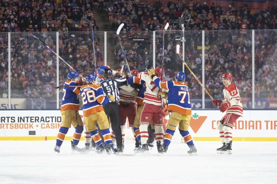 Calgary Flames and Edmonton Oilers skirmish during second-period NHL Heritage Classic outdoor hockey game action in Edmonton, Alberta, Sunday, Oct. 29, 2023. (Jason Franson/The Canadian Press via AP)