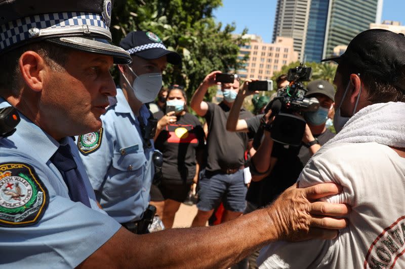 Protesters and police clash during a march on Australia Day in Sydney