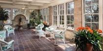 Those French doors give onto a huge solarium with a coffered ceiling with plaster detailing.