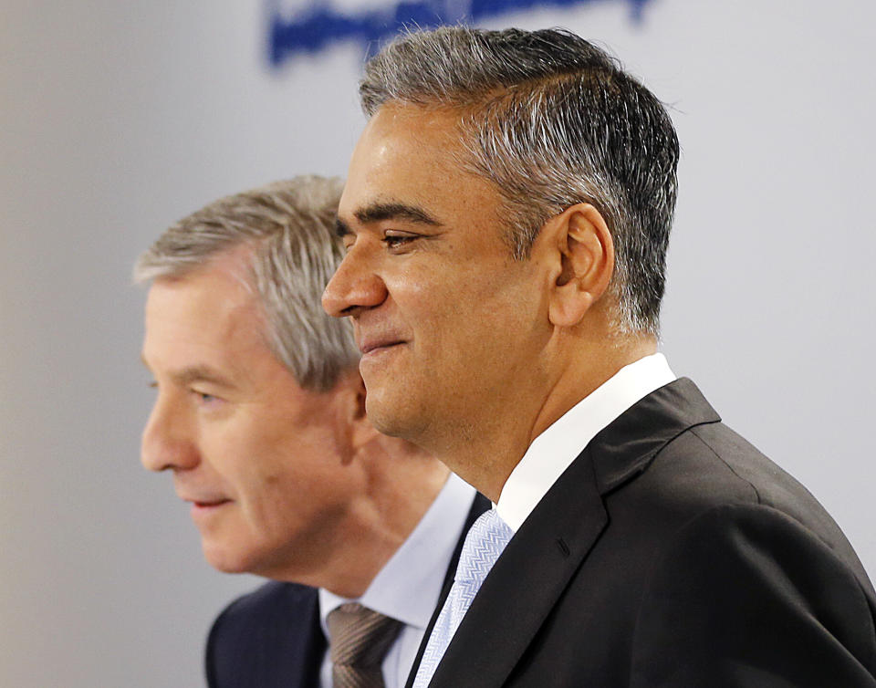 CEOs of Deutsche Bank Anshu Jain, right, and Juergen Fitschen stand together prior to the annual press conference in Frankfurt, Germany, Wednesday, Jan. 29, 2014. Germany's biggest bank had a surprise loss of 965 million euros (US dollar 1.32 billion) in the fourth quarter, as earnings were burdened by 528 million in costs for court settlements and investigations into alleged past misconduct in the fourth quarter. (AP Photo/Michael Probst)