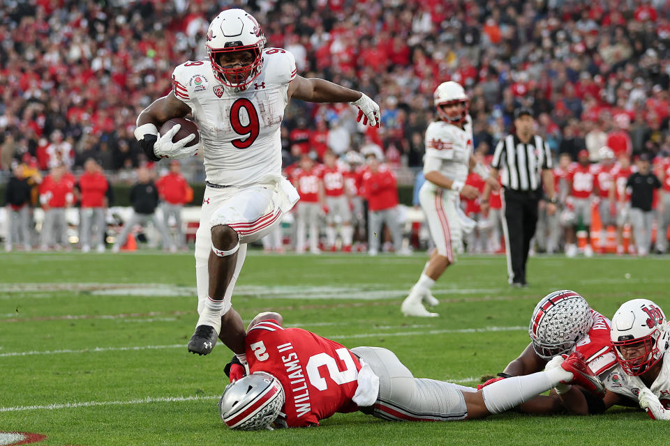 PASADENA, CALIFORNIA - JANUARY 01: Tavion Thomas #9 of the Utah Utes leaps past Kourt Williams II #2 of the Ohio State Buckeyes during the second half of the Rose Bowl game at Rose Bowl Stadium on January 01, 2022 in Pasadena, California. (Photo by Sean M. Haffey/Getty Images)