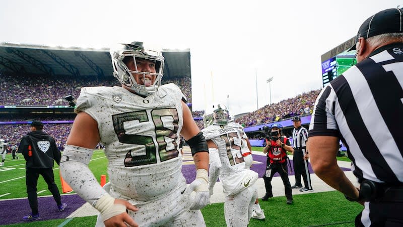 Oregon offensive lineman Jackson Powers-Johnson reacts after wide receiver Tez Johnson (15) made a two-point conversion catch against Washington, Saturday, Oct. 14, 2023, in Seattle. Powers-Johnson could be the first player with Utah ties selected in this week's NFL draft.