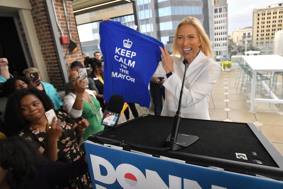Donna Deegan holds up a t-shirt that her daughter bought her as she addressed supporters after winning Jacksonville's election for Mayor.
