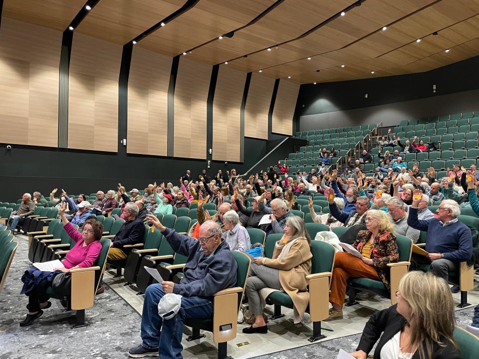 Voters raised their hands on Thursday at the Dennis special town meeting in favor of purchasing a former seasonal church building and its parking lot for $2.3 million. The meeting was held at the Dennis-Yarmouth Intermediate School in South Yarmouth.