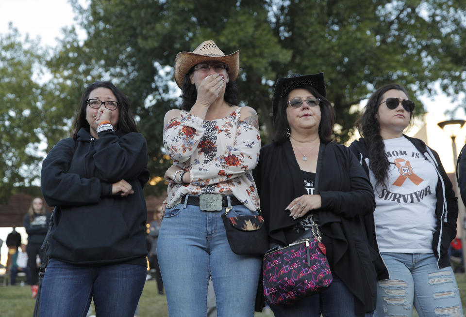 From left, Yvonne Justice, Emily Sebring and Tami Gapuz attend a ceremony Tuesday, Oct. 1, 2019, on the anniversary of the mass shooting two years earlier, Las Vegas. (AP Photo/John Locher)