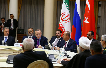 Turkish President Tayyip Erdogan speaks during a meeting with his counterparts Vladimir Putin of Russia and Hassan Rouhani of Iran in Sochi, Russia, November 22, 2017. Kayhan Ozer/Turkish Presidential Palace/Handout via REUTERS