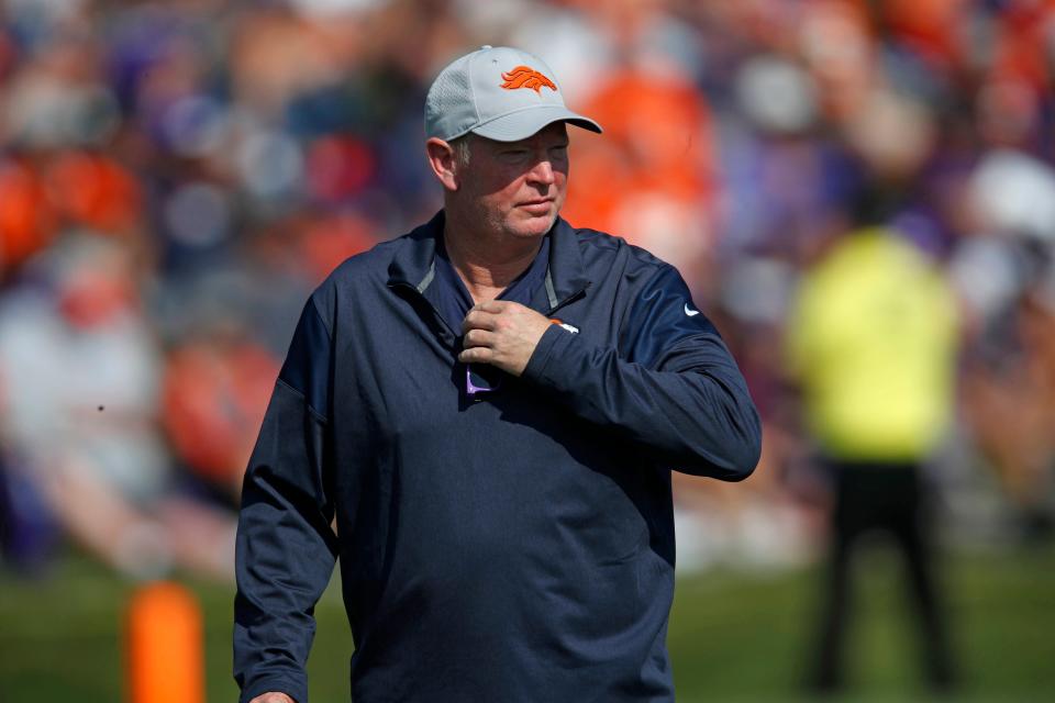 FILE - In this Aug. 4, 2018, file photo, then-Denver Broncos offensive coordinator Bill Musgrave takes part in drills at the team's headquarters during an NFL football training camp in Englewood, Colo. After a pandemic-shortened 2020 season, the California Golden Bears are excited to show off what they hope will be a much more dynamic offense with respected longtime NFL coordinator Bill Musgrave and veteran quarterback Chase Garbers. (AP Photo/David Zalubowski, File)