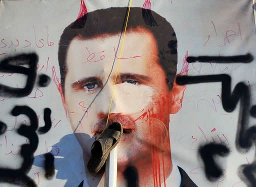 A slipper hangs on a vandalised poster of Syrian President Bashar al-Assad lying in a trash container in the northern city of Aleppo. A commercial hub and home to 2.5 million people, Syria's second city Aleppo has become a new front in the country's 16-month uprising, after being largely excluded from the violence