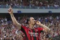 AC Milan's Zlatan Ibrahimovic puffs a cigar as he celebrates after winning a Serie A soccer match between AC Milan and Sassuolo, in Reggio Emilia's Mapei Stadium, Italy, Sunday, May 22, 2022. AC Milan secured its first Serie A title in 11 years on Sunday with a 3-0 win at Sassuolo. (Spada/LaPresse via AP)
