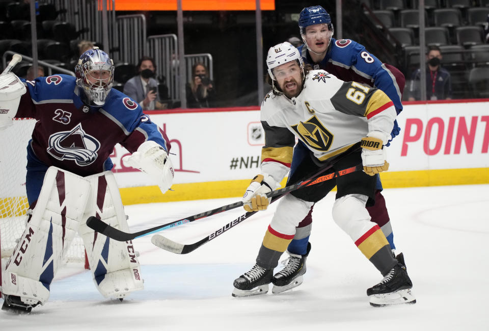 Vegas Golden Knights right wing Mark Stone, front right, calls for the puck while covered by Colorado Avalanche defenseman Cale Makar, back right, next to goaltender Philipp Grubauer during the third period of Game 5 of an NHL hockey Stanley Cup second-round playoff series Tuesday, June 8, 2021, in Denver. (AP Photo/David Zalubowski)