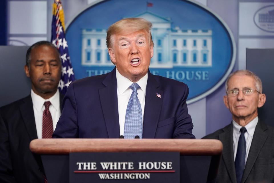 President Trump with Ben Carson, secretary of Housing and Urban Development, left, and Dr. Anthony Fauci, director of the National Institute of Allergy and Infectious Diseases Anthony Fauci. (Joshua Roberts/Reuters)