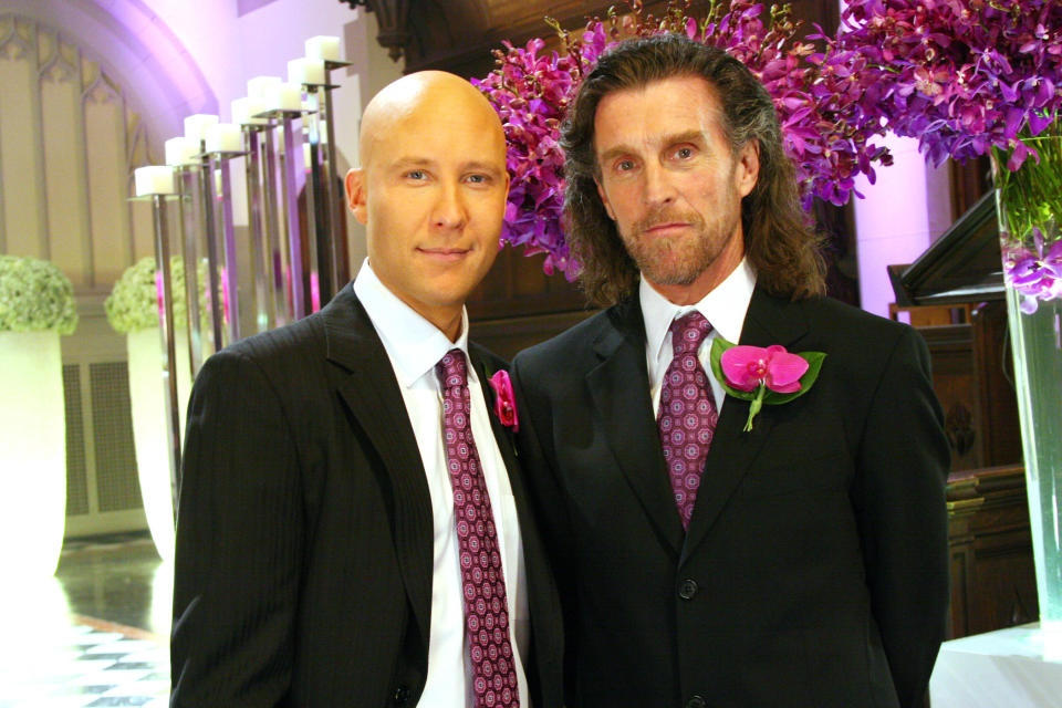 Lex and Lionel Luthor (Michael Rosenbaum and John Glover) strike a family pose in 'Smallville' (Photo: Michael Courtney / © Warner Brothers Television / Courtesy Everett Collection)