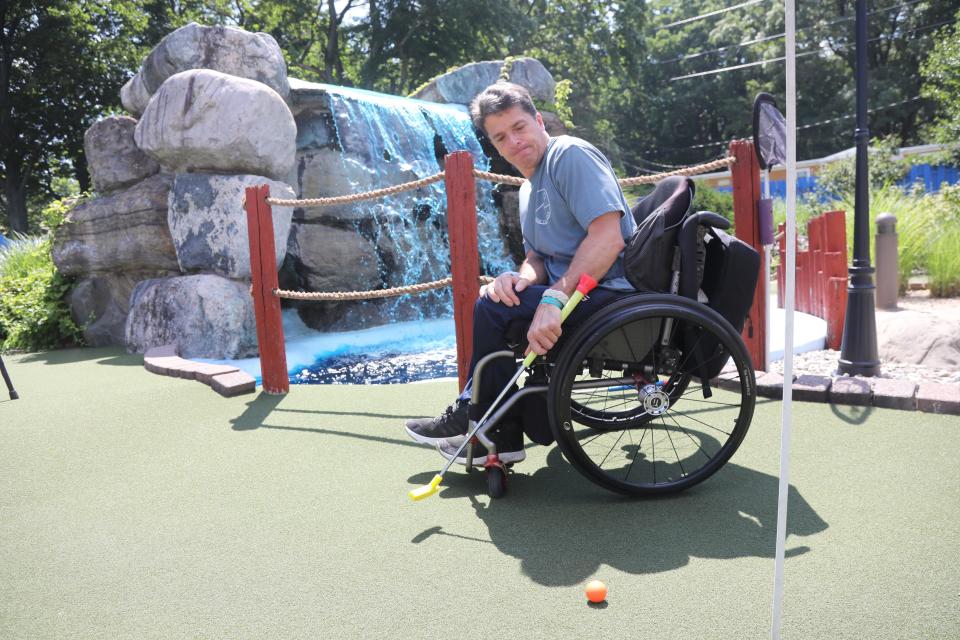 Scott Chesney putts the ball on the green. Reporter Gene Myers and Verona's Scott Chesney share mishaps and adventure while considering ADA guidelines, here in at Castle Cove Mini Golf in Jefferson, NJ on July 22, 2022.