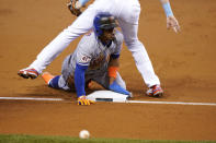 New York Mets' Francisco Lindor slides safely into third before going on to score on a throwing error by Miami Marlins center fielder Magneuris Sierra during the first inning of a baseball game Friday, May 21, 2021, in Miami. (AP Photo/Lynne Sladky)