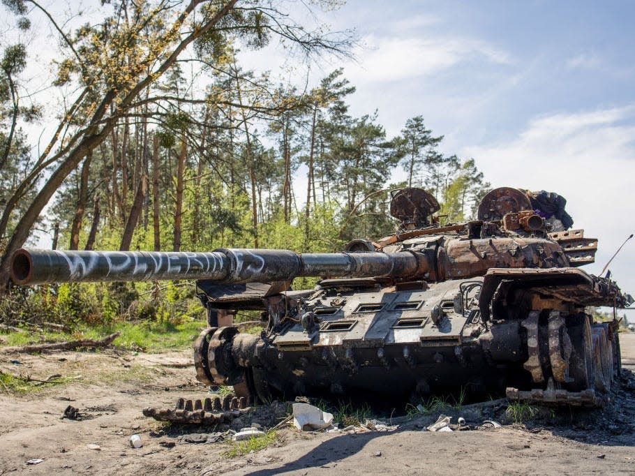 A destroyed Russian tank seen with graffiti on it in Kyiv Oblast.