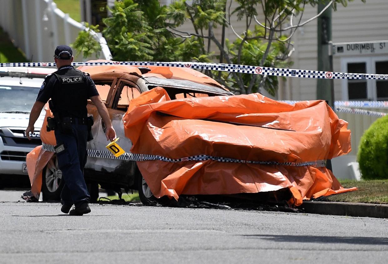 Police work at the scene of a car fire in Brisbane, Australia, where four people died, including three young children, and a woman suffered extensive injuries: EPA