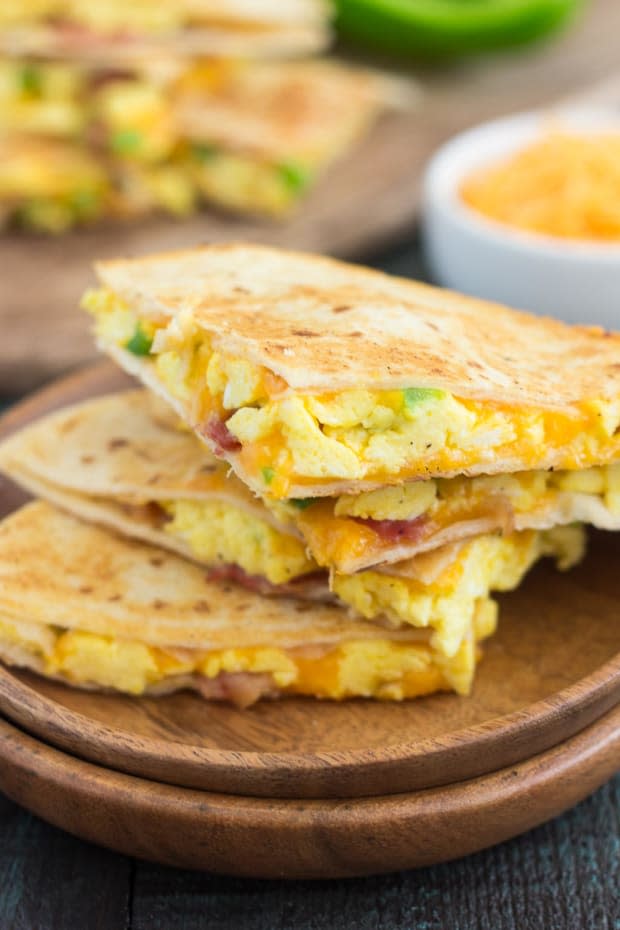 <p>These easy breakfast quesadillas are filled with fluffy scrambled eggs, green peppers, bacon and cheddar cheeses, all enveloped between two crispy tortilla shells. It’s an easy meal that’s perfect for busy mornings!</p><p><strong>Get the recipe: <a href="https://www.pumpkinnspice.com/easy-breakfast-quesadillas/" rel="nofollow noopener" target="_blank" data-ylk="slk:Easy Breakfast Quesadillas;elm:context_link;itc:0;sec:content-canvas" class="link "><em>Easy Breakfast Quesadillas</em></a></strong></p><p>Pumpkin 'n Spice</p>