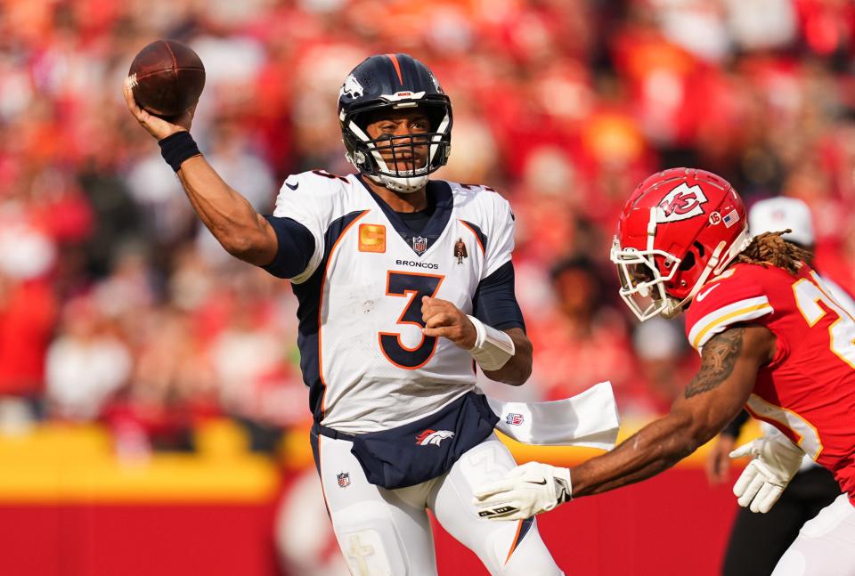 Denver Broncos quarterback Russell Wilson (3) throws a pass as Kansas City Chiefs safety Justin Reid (20) defends during the first half at GEHA Field at Arrowhead Stadium.