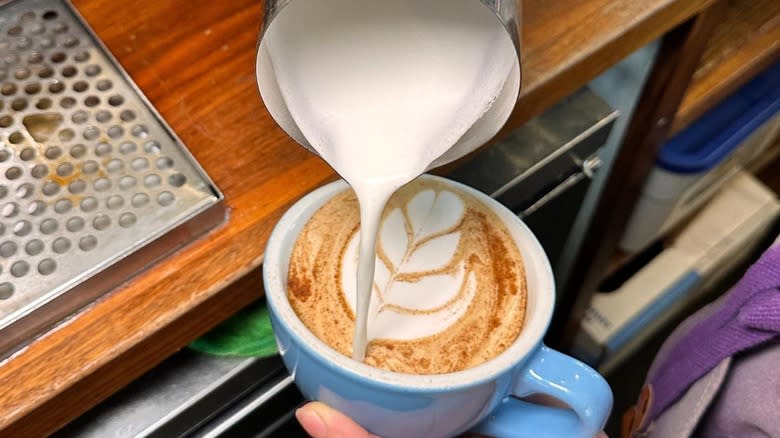 Barista pouring coffee at Mothership Coffee Roasters