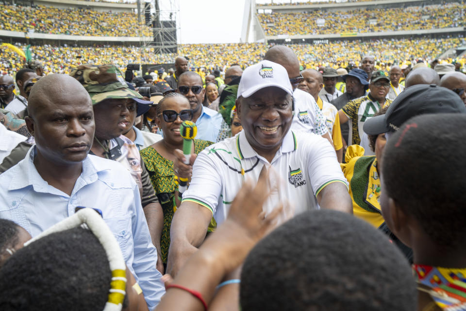 Greeted by African National Congress supporters, South African President Cyril Ramaphosa arrives at the Mose Mabhida stadium in Durban, South Africa, Saturday, Feb. 24, 2024, for their national manifesto launch in anticipation of the 2024 general elections. (AP Photo/Jerome Delay)