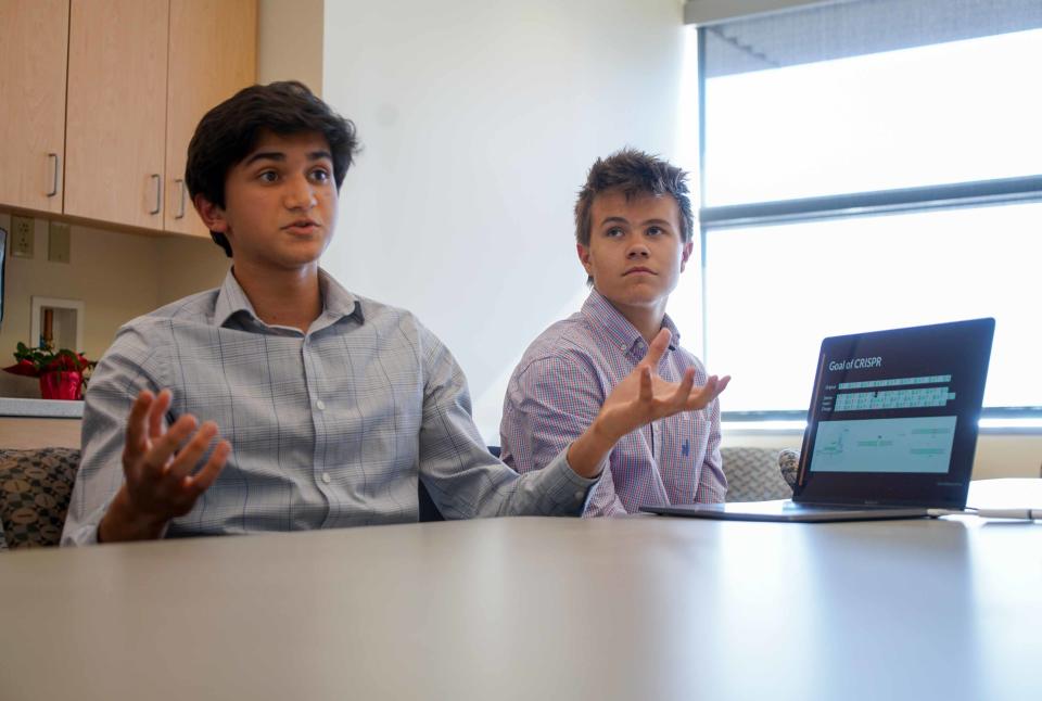 Rohan Kanchana, 16, left, a junior at Newark Charter School, talks about how he used his coding skills to creator the computer program DECODR as Ben Dupont, 17, a senior at Tower Hill, listens.